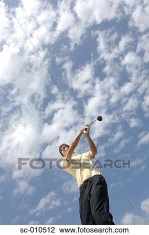 High angle view of a man playing a golf stroke View Large Photo Image Stock Image - High angle view of a man playing a golf stroke. Fotosearch
