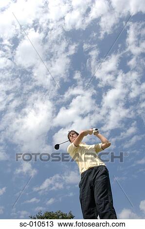 Stock Image - High angle view of a man playing a golf stroke. Fotosearch