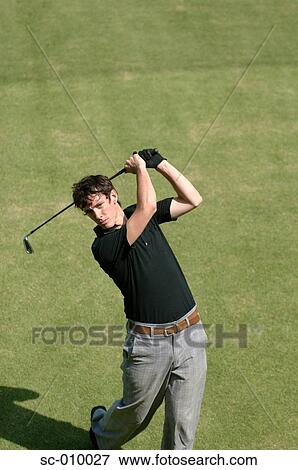 Stock Photo - High angle view of a man playing a golf stroke. Fotosearch