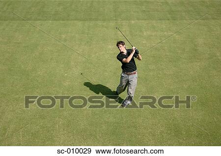 Stock Photo - High angle view of a man playing a golf stroke. Fotosearch