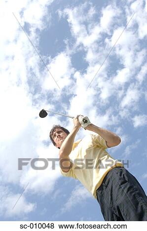 Stock Photo - High angle view of a man playing a golf stroke. Fotosearch