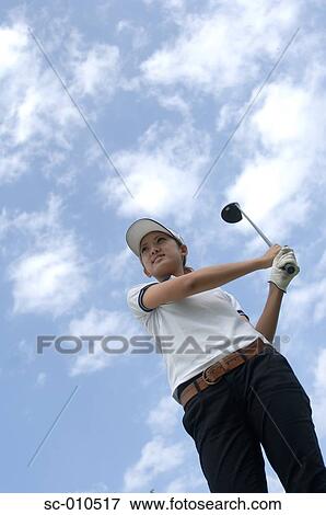 High angle view of a woman playing a golf stroke View Large Photo Image Stock Photo - High angle view of a woman playing a golf stroke. Fotosearch