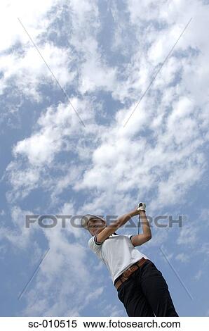 Stock Photography - High angle view of a woman playing a golf stroke. Fotosearch