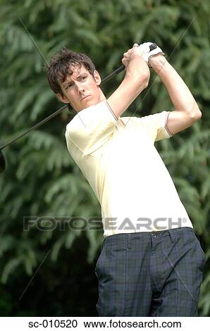 Stock Image - Portrait of a man playing a golf stroke. Fotosearch