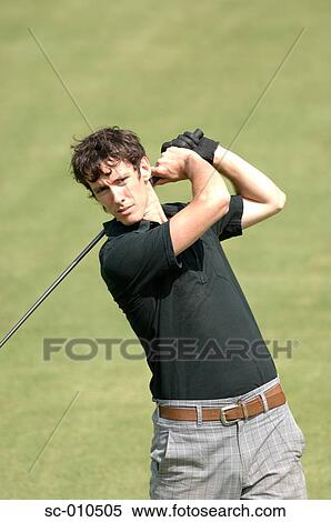 Stock Photography - Portrait of a man playing a golf stroke. Fotosearch