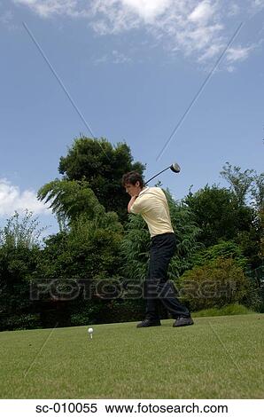 Side view of a man playing a golf shot View Large Photo Image Stock Photography - Side view of a man playing a golf shot. Fotosearch
