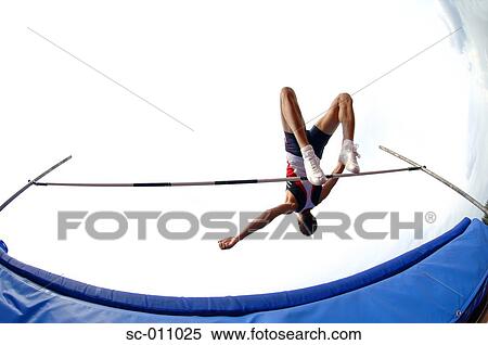 Stock Photography - Male High Jumper Clearing the Bar. Fotosearch