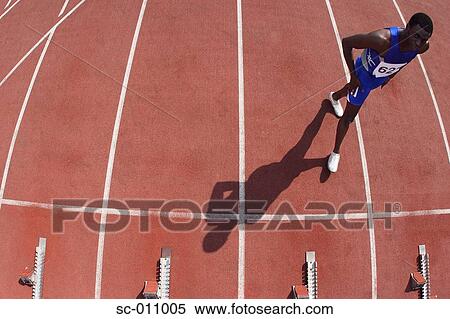 Stock Photography - Male Runner Approaching Starting Blocks. Fotosearch