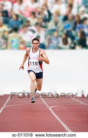 Male Runner Sprinting Down a Track View Large Photo Image Stock Photo - Male Runner Sprinting Down a Track. Fotosearch