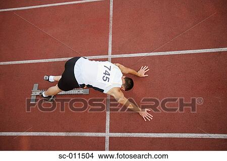 Male Runner Stretching on the Starting Blocks View Large Photo Image Picture - Male Runner Stretching on the Starting Blocks. Fotosearch
