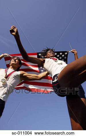 Picture - Male Runners Carrying US Flag. Fotosearch