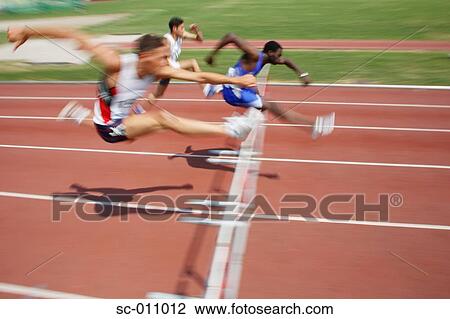 Stock Image - Male Runners Clearing Hurdle. Fotosearch
