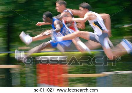 Stock Photo - Male Runners Clearing Hurdle. Fotosearch