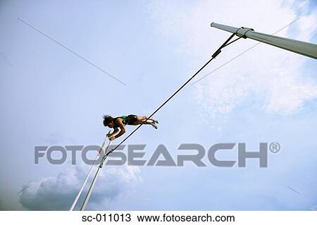 Stock Image - Man Pole Vaulting. Fotosearch