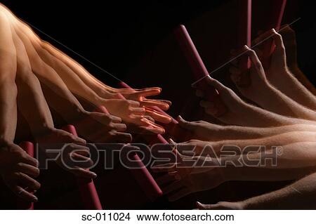 Picture - Runners Passing Baton. Fotosearch