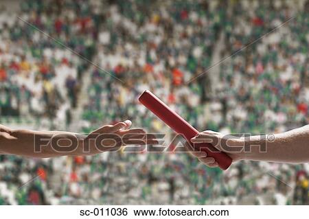Two Runners Passing Baton In Stadium View Large Photo Image Stock Photograph - Two Runners Passing Baton In Stadium. Fotosearch