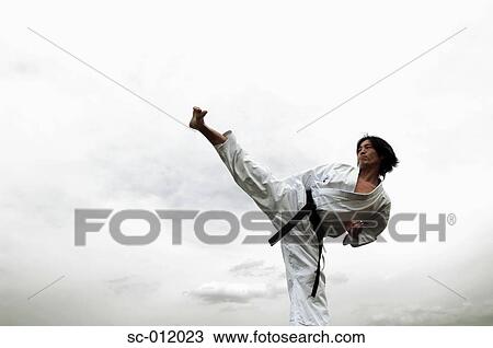 Stock Image - Blackbelt Breaking Boards. Fotosearch