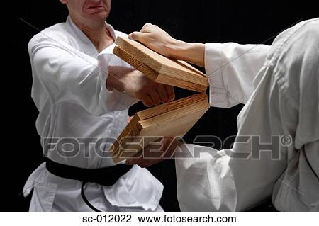 Stock Image - Blackbelt Doing a Flying Kick. Fotosearch