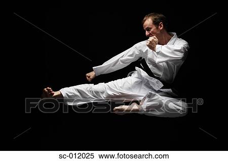 Blackbelt Doing a Flying Kick View Large Photo Image Stock Photography - Blackbelt Doing a Flying Kick. Fotosearch