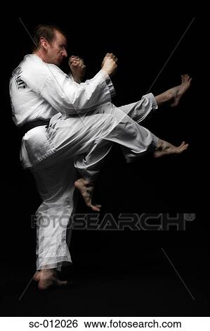 Stock Photograph - Blackbelt Doing a Front Kick. Fotosearch