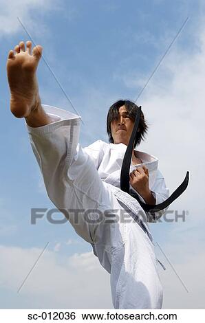 Stock Photograph - Blackbelt Doing a Front Kick. Fotosearch