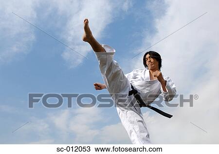 Stock Image - Blackbelt Doing Front Kick. Fotosearch