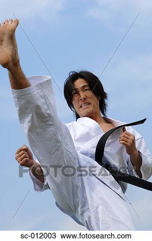 Stock Image - Blackbelt Kicking. Fotosearch
