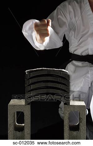Stock Photography - Blackbelt Preparing to Break a Stack of Concrete Blocks. Fotosearch