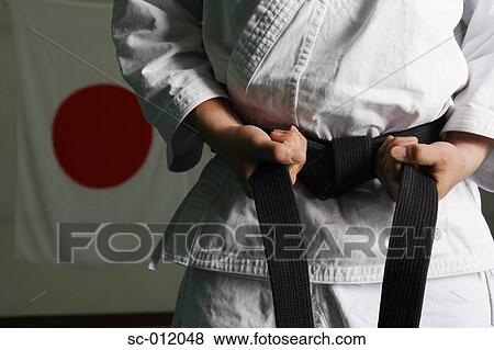 Taekwondo Fighter Tightening Belt View Large Photo Image Stock Photo - Taekwondo Fighter Tightening Belt. Fotosearch