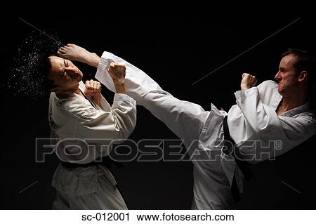 Stock Image - Two Blackbelts Sparring. Fotosearch