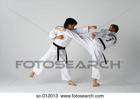 Stock Image - Two Blackbelts Sparring. Fotosearch