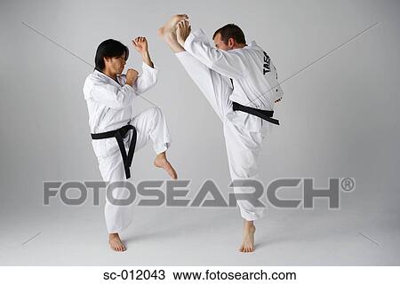 Stock Image - Two Blackbelts Sparring. Fotosearch