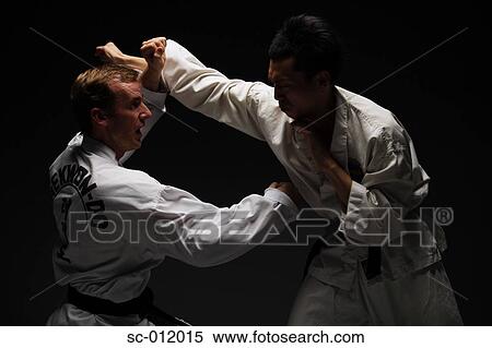 Stock Photography - Two Blackbelts Sparring. Fotosearch