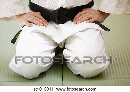 Stock Image - Judo Master Kneeling On a Mat. Fotosearch