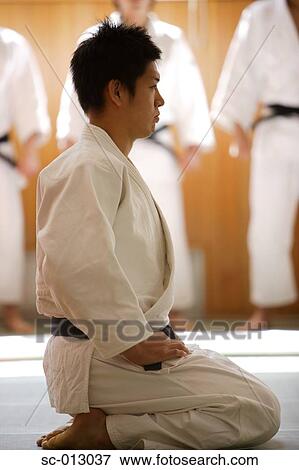 Stock Photo - Judo Master Kneeling On a Mat. Fotosearch