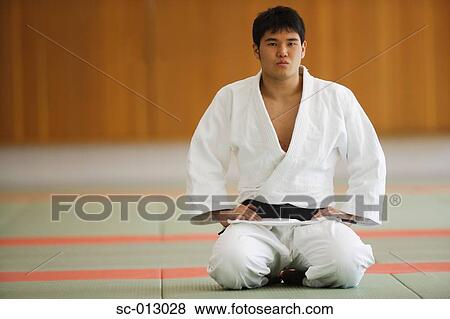 Judo Student Kneeling on Mats View Large Photo Image Stock Photo - Judo Student Kneeling on Mats. Fotosearch