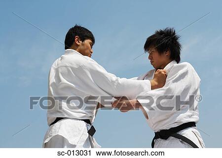 Stock Image - Two Men Competing in a Judo Match. Fotosearch