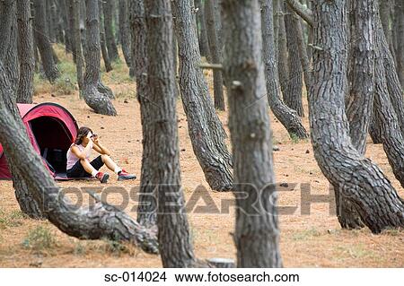 Young female camper looking through binoculars View Large Photo Image Picture - Young female camper looking through binoculars. Fotosearch