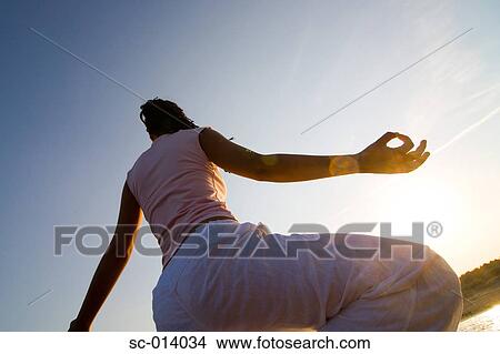 Picture - Young woman doing yoga exercises. Fotosearch