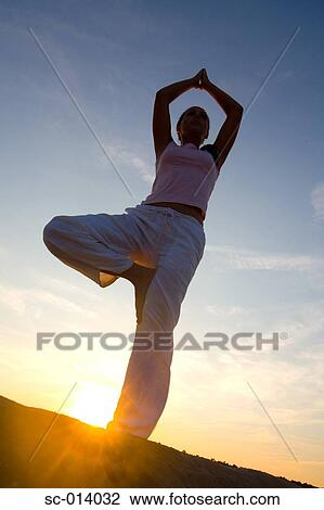 Young woman doing yoga exercises View Large Photo Image Stock Image - Young woman doing yoga exercises. Fotosearch