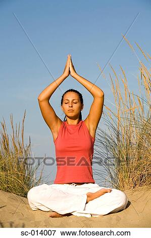 Stock Photo - Young woman doing yoga exercises. Fotosearch