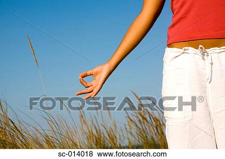 Stock Photo - Young woman doing yoga exercises. Fotosearch