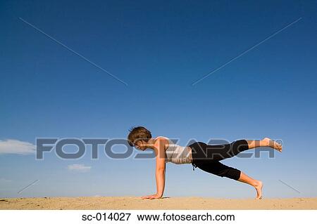 Stock Photo - Young woman exercising. Fotosearch
