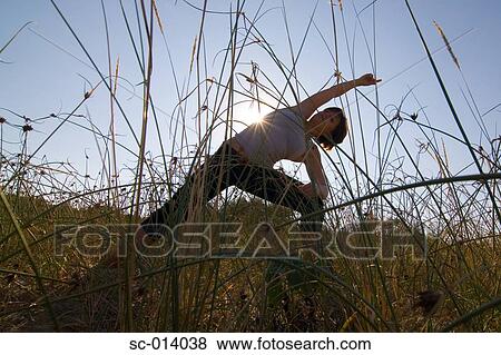 Stock Photo - Young woman exercising. Fotosearch