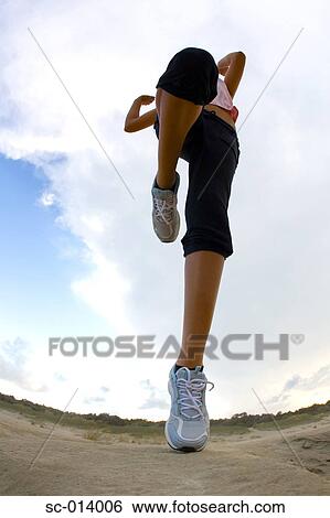 Stock Photograph - Young woman exercising. Fotosearch