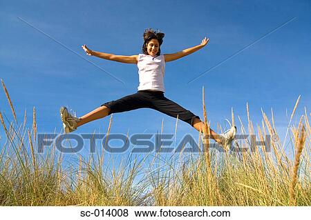 Stock Photo - Young woman jumping. Fotosearch