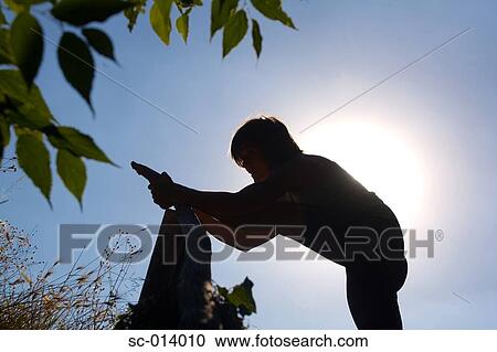 Young woman silhouetted against sun View Large Photo Image Stock Image - Young woman silhouetted against sun. Fotosearch