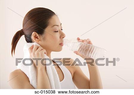Young Asian woman drinking water View Large Photo Image Stock Photo - Young Asian woman drinking water. Fotosearch