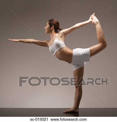 Young Asian woman in king dancer pose View Large Photo Image Stock Image - Young Asian woman in king dancer pose. Fotosearch