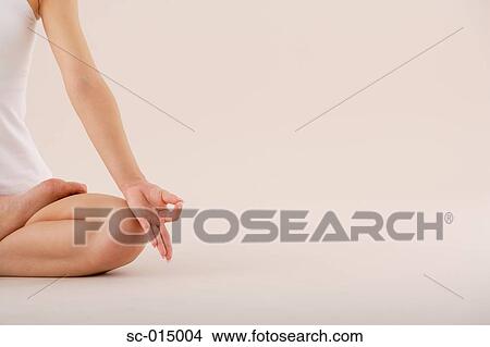 Picture - Young Asian woman in lotus position. Fotosearch